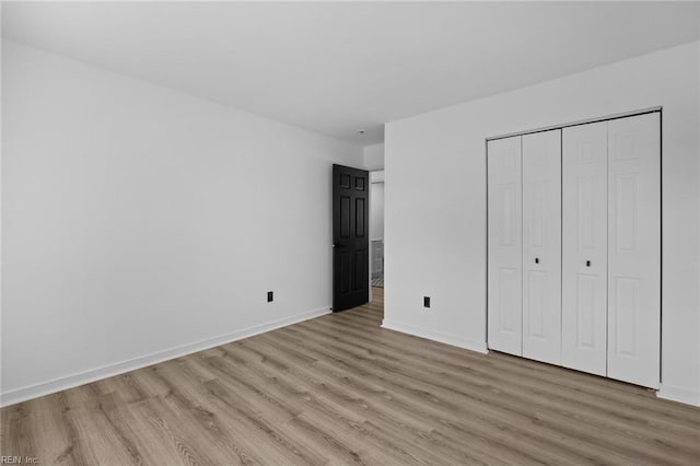 130 Rochdale Ln, Suffolk, VA 23434 - unfurnished bedroom with light wood-type flooring, baseboards, and a closet