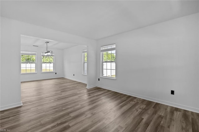 130 Rochdale Ln, Suffolk, VA 23434 - spare room with dark wood finished floors, baseboards, and a chandelier