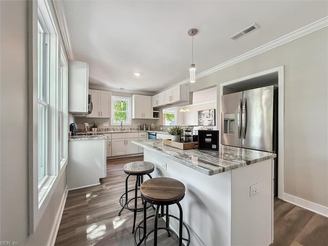134 Chesterfield Rd, Hampton, VA 23661 - kitchen with stainless steel fridge with ice dispenser, dark wood-style floors, white cabinetry, a kitchen breakfast bar, and crown molding