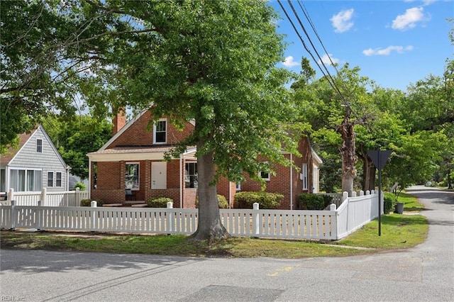134 Chesterfield Rd, Hampton, VA 23661 - view of front of house with a chimney, brick siding, a fenced front yard, and a porch