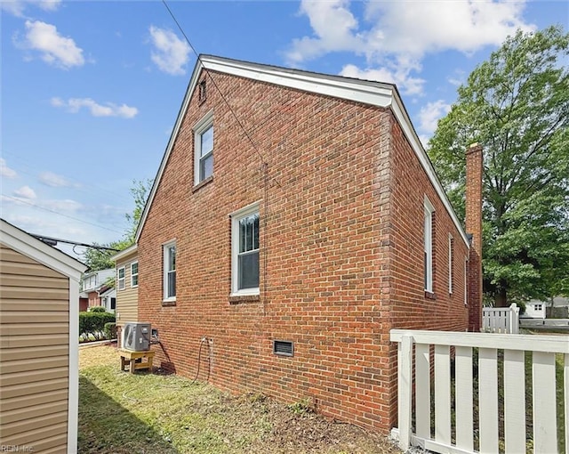 134 Chesterfield Rd, Hampton, VA 23661 - view of home's exterior with brick siding, a cooling unit, and a chimney