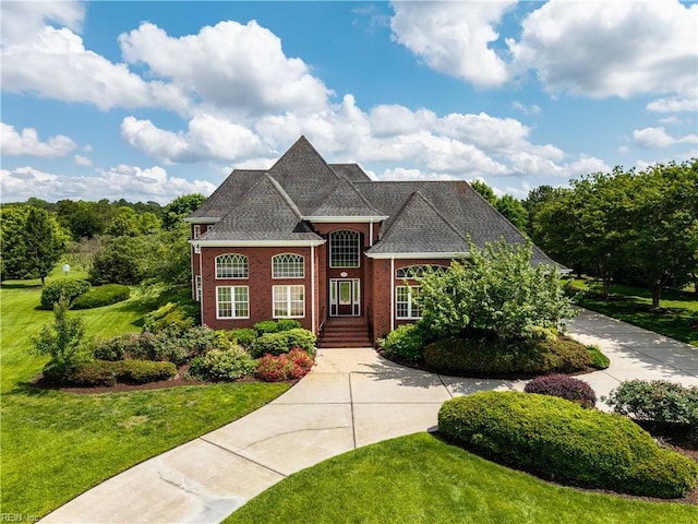909 Two Gates Cir, Chesapeake, VA 23322 - french provincial home featuring a front lawn, curved driveway, and brick siding