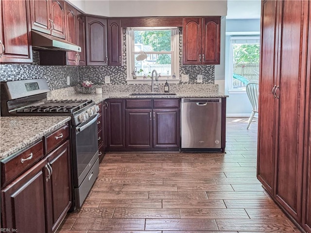 1907 Eastborne Dr, Virginia Beach, VA 23454 - kitchen featuring stainless steel appliances, under cabinet range hood, a sink, dark wood-type flooring, and backsplash