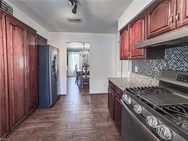 1907 Eastborne Dr, Virginia Beach, VA 23454 - kitchen featuring appliances with stainless steel finishes, a chandelier, under cabinet range hood, dark wood-style floors, and baseboards