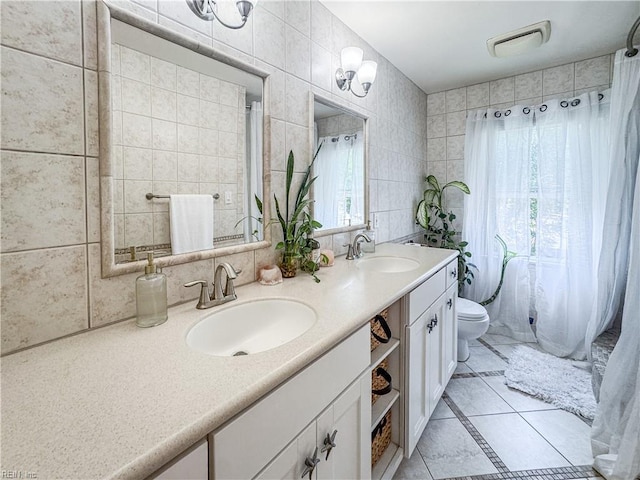 1907 Eastborne Dr, Virginia Beach, VA 23454 - bathroom featuring tile patterned flooring, toilet, double vanity, and tile walls