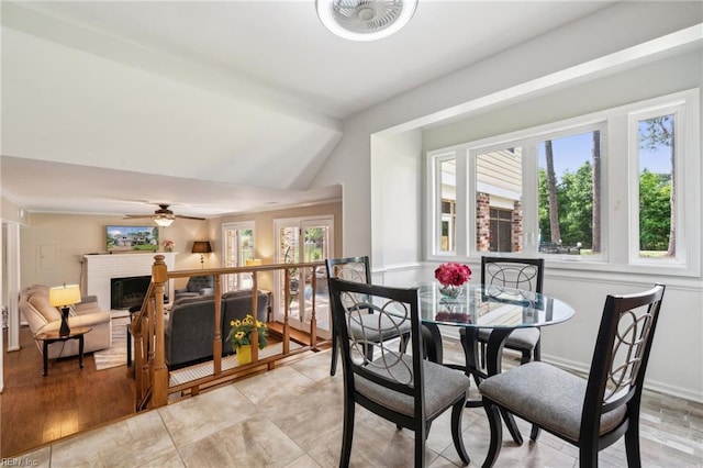 108 Bayview Dr, Yorktown, VA 23692 - dining room with vaulted ceiling, a ceiling fan, and a brick fireplace