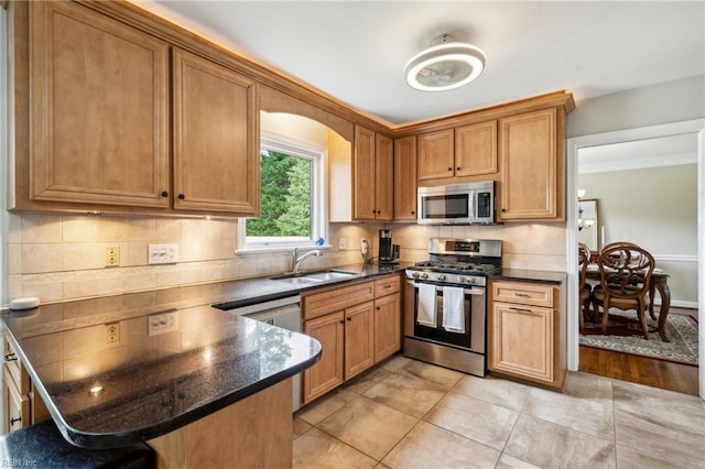 108 Bayview Dr, Yorktown, VA 23692 - kitchen with appliances with stainless steel finishes, a sink, dark countertops, a peninsula, and tasteful backsplash