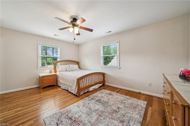 108 Bayview Dr, Yorktown, VA 23692 - bedroom with multiple windows, baseboards, light wood-style flooring, and a ceiling fan