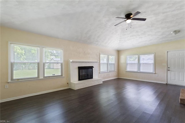 2212 Wildwood Rd, Chesapeake, VA 23323 - unfurnished living room featuring vaulted ceiling, dark wood-type flooring, baseboards, ceiling fan, and a brick fireplace