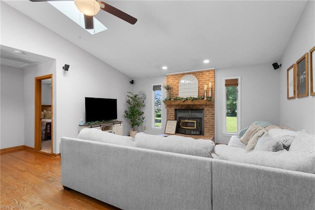 living room with a ceiling fan, recessed lighting, light wood-style flooring, lofted ceiling, and baseboards