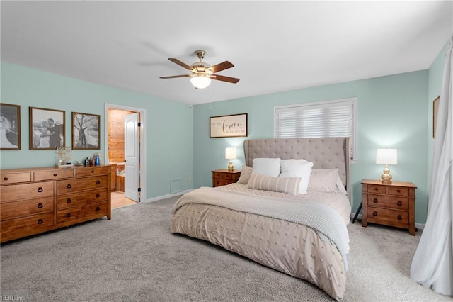 bedroom featuring carpet flooring, ceiling fan, ensuite bathroom, and baseboards