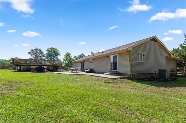 back of house featuring central AC, a lawn, a patio, and entry steps