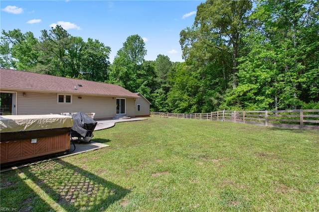 view of yard with a hot tub and a patio