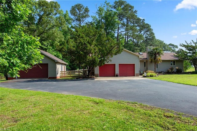 view of front facade featuring asphalt driveway and an attached garage