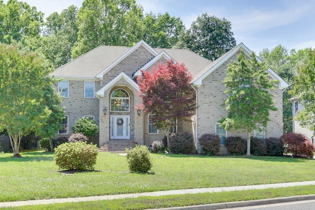traditional-style home with a front lawn and brick siding