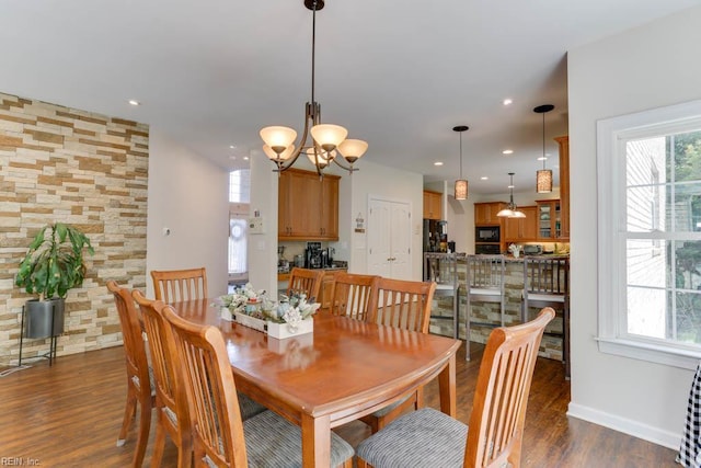 dining area with wood finished floors, a chandelier, baseboards, and recessed lighting