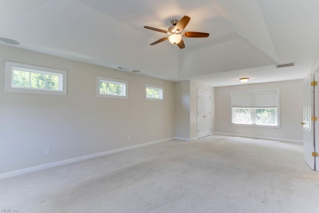 spare room with baseboards, a ceiling fan, and light carpet