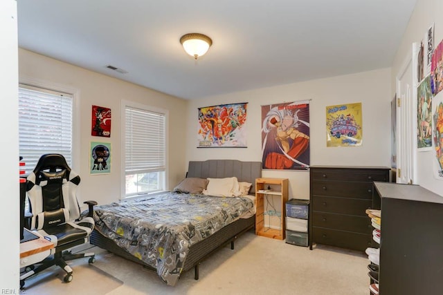bedroom featuring light carpet