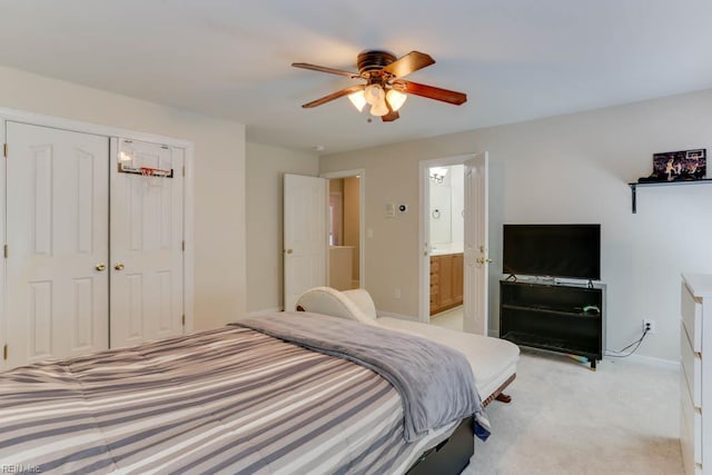 bedroom featuring light colored carpet, baseboards, a ceiling fan, connected bathroom, and a closet