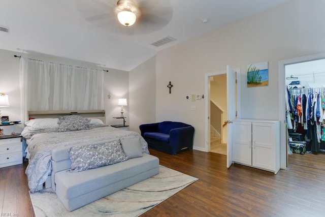 bedroom with wood finished floors, a spacious closet, a closet, and a ceiling fan