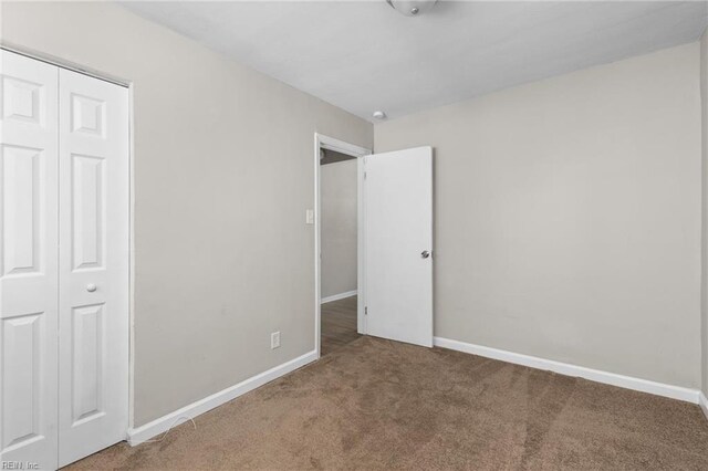 910 Truman Rd, Suffolk, VA 23434 - unfurnished bedroom featuring carpet floors, a closet, and baseboards