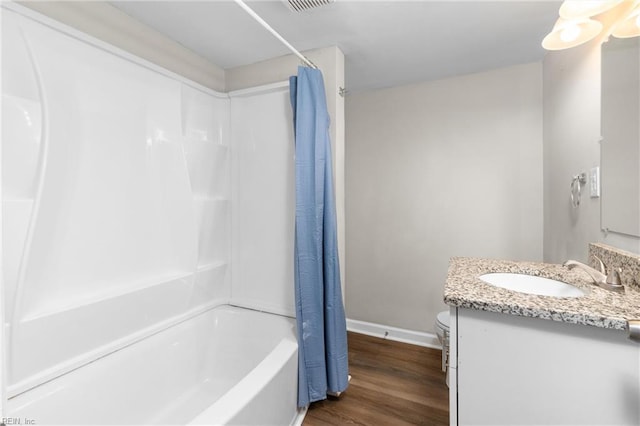 910 Truman Rd, Suffolk, VA 23434 - bathroom with baseboards, wood finished floors, vanity, and shower / bath combo with shower curtain