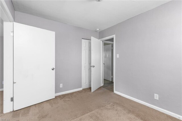 910 Truman Rd, Suffolk, VA 23434 - unfurnished bedroom featuring carpet flooring, baseboards, and a closet