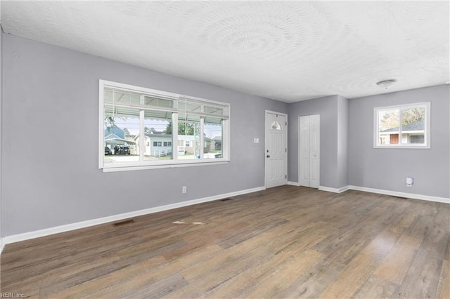 910 Truman Rd, Suffolk, VA 23434 - foyer entrance featuring baseboards, wood finished floors, and a textured ceiling