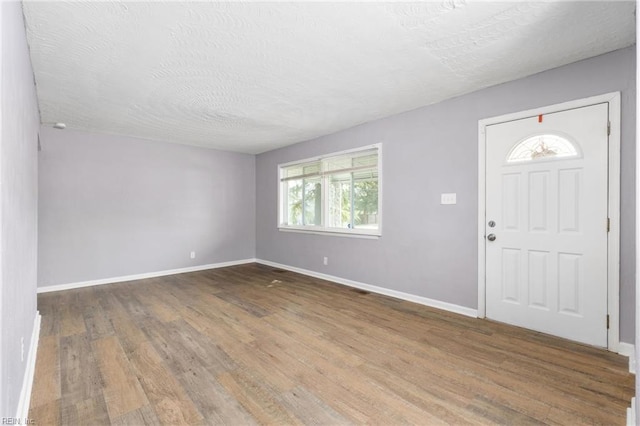 910 Truman Rd, Suffolk, VA 23434 - foyer entrance with wood finished floors, baseboards, and a textured ceiling