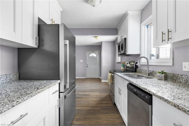 910 Truman Rd, Suffolk, VA 23434 - kitchen with stainless steel appliances, a sink, white cabinets, and dark wood-style floors