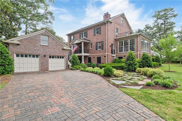 7320 Shirland Ave, Norfolk, VA 23505 - view of front facade with brick siding, a garage, a chimney, decorative driveway, and a front yard
