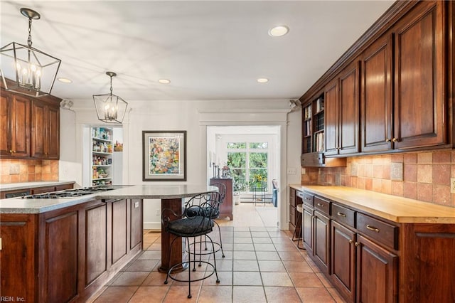 7320 Shirland Ave, Norfolk, VA 23505 - kitchen with a kitchen bar, a chandelier, recessed lighting, tasteful backsplash, and pendant lighting