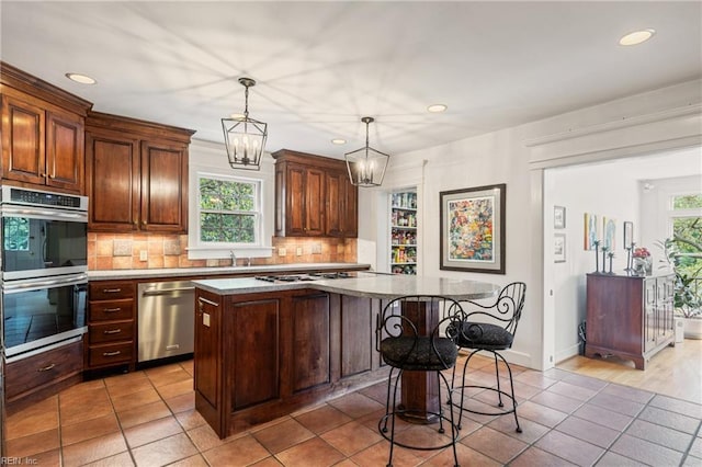 7320 Shirland Ave, Norfolk, VA 23505 - kitchen with stainless steel appliances, decorative backsplash, recessed lighting, a center island, and a breakfast bar