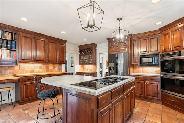 7320 Shirland Ave, Norfolk, VA 23505 - kitchen featuring black appliances, backsplash, light tile patterned flooring, a kitchen island, and recessed lighting