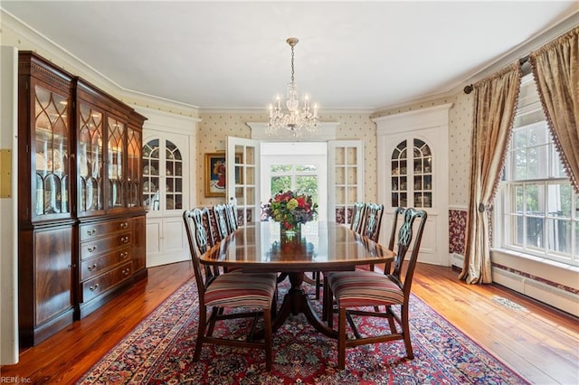 7320 Shirland Ave, Norfolk, VA 23505 - dining space featuring wallpapered walls, ornamental molding, a chandelier, hardwood / wood-style flooring, and plenty of natural light