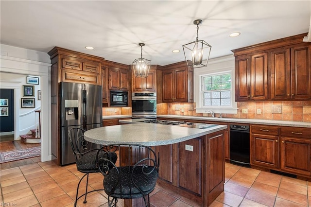 7320 Shirland Ave, Norfolk, VA 23505 - kitchen featuring appliances with stainless steel finishes, backsplash, recessed lighting, a kitchen island, and decorative light fixtures