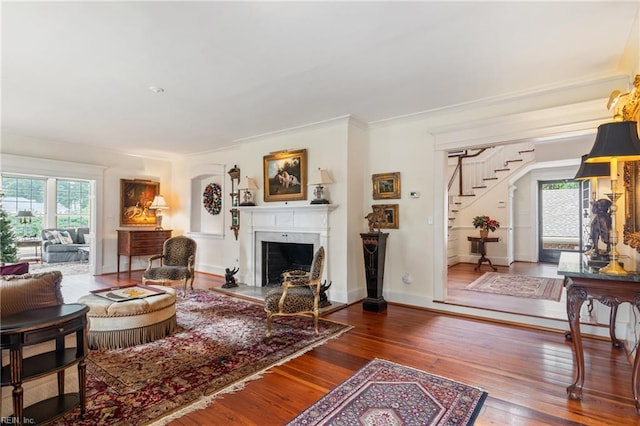 7320 Shirland Ave, Norfolk, VA 23505 - living area with stairs, plenty of natural light, hardwood / wood-style flooring, a fireplace with flush hearth, and crown molding