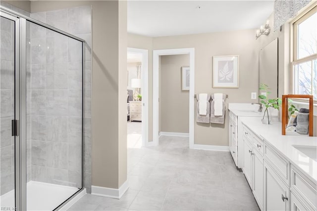 1129 Egret Ln, Suffolk, VA 23434 - bathroom featuring a stall shower, baseboards, and double vanity