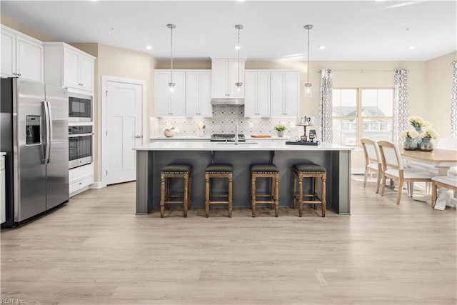 1129 Egret Ln, Suffolk, VA 23434 - kitchen with appliances with stainless steel finishes, light wood-style flooring, a sink, tasteful backsplash, and recessed lighting