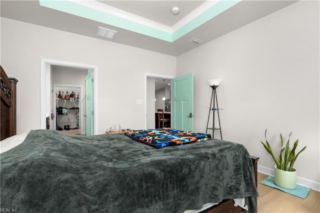 bedroom featuring wood finished floors and baseboards