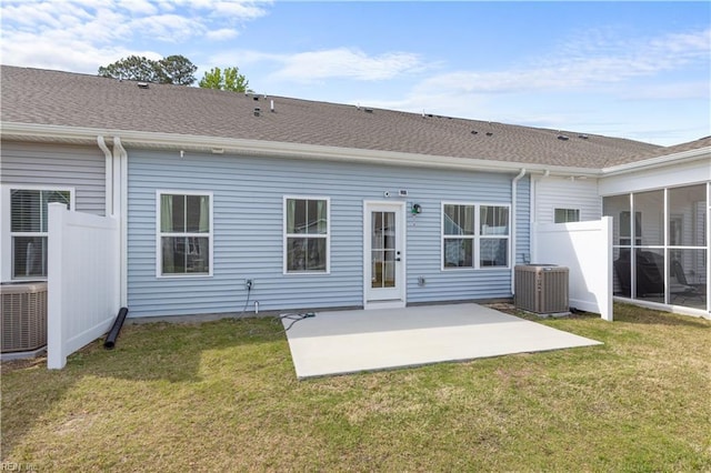 back of house with central AC unit, a patio area, a yard, and a sunroom