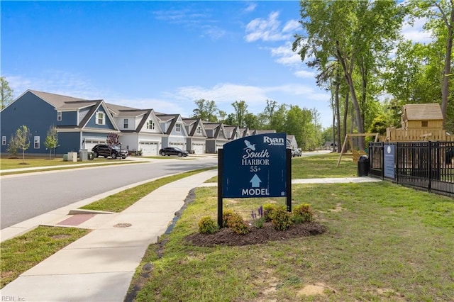 view of asphalt street featuring sidewalks and a residential view