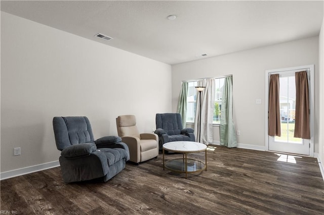sitting room featuring dark wood-type flooring and baseboards