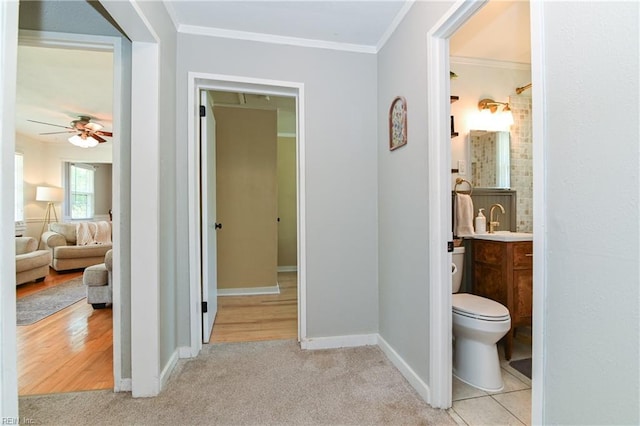 104 Hodges Manor Rd, Portsmouth, VA 23701 - corridor featuring crown molding, baseboards, carpet floors, and a sink
