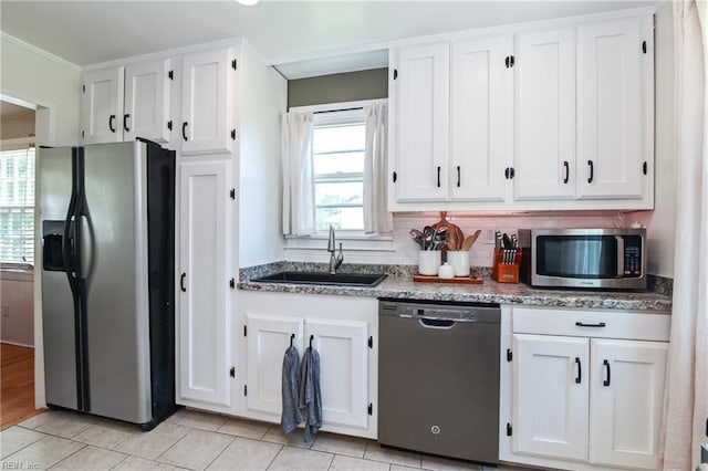 104 Hodges Manor Rd, Portsmouth, VA 23701 - kitchen with appliances with stainless steel finishes, a sink, white cabinets, light stone counters, and backsplash