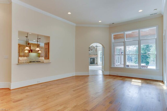 321 Tindalls Ct, Suffolk, VA 23436 - unfurnished living room with light wood-style flooring, crown molding, recessed lighting, baseboards, and a stone fireplace