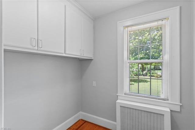 9913 River Rd, Newport News, VA 23601 - washroom with plenty of natural light, baseboards, radiator heating unit, and wood finished floors