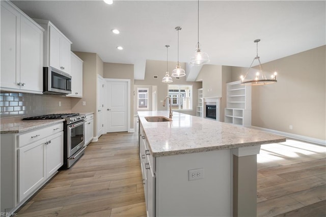 1008 Libby Way, Suffolk, VA 23435 - kitchen with a sink, appliances with stainless steel finishes, light wood-style floors, baseboards, and an island with sink