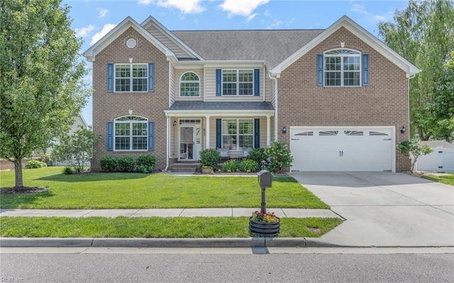 traditional home with a garage, concrete driveway, brick siding, and a front yard