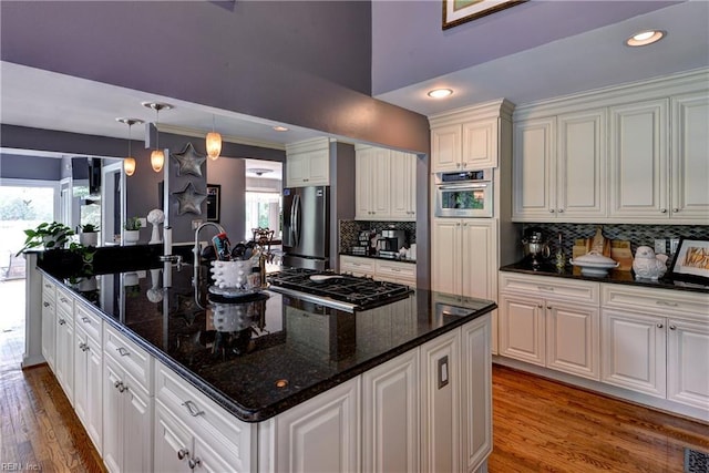 103 Acacia Ct, Williamsburg, VA 23185 - kitchen with appliances with stainless steel finishes, backsplash, white cabinets, wood finished floors, and pendant lighting